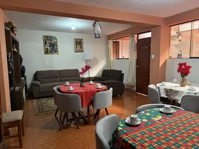 a living room with a red table and chairs at Chabela Host in Cusco
