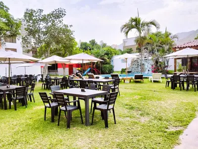 a group of tables and chairs with umbrellas at Tambo II Hotel Campestre in Cieneguilla