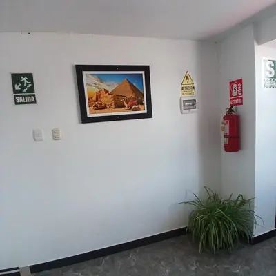 a white wall with a picture of a building on it at HOSTAl EGIPTO in Ayacucho