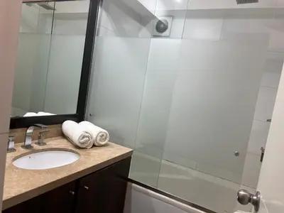 a bathroom with a sink and a shower at Urbano Apartments Miraflores Pardo in Lima
