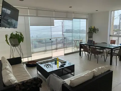a living room with a couch and a table at Departamento San Bartolo, Excellent Location! in San Bartolo