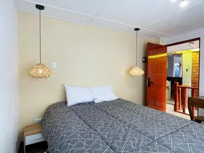 a bedroom with a bed with two pillows at La Casa del Valle - Huaripampa in Huaripampa