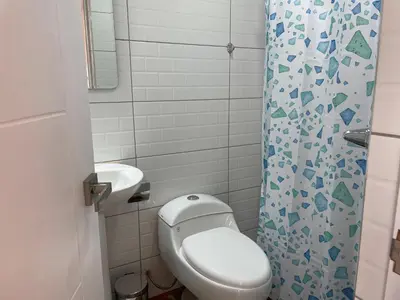 a small bathroom with a toilet and a sink at La Casa del Valle - Huaripampa in Huaripampa