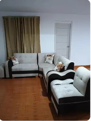 a living room with a couch and a chair at Departamento Acogedor en Surco in Lima