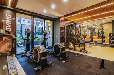 a gym with treadmills and machines in a room at Perfect location in Barranco in Lima