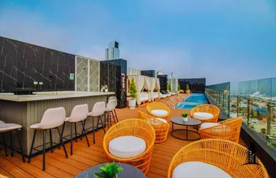 a balcony with chairs and tables and a bar at Perfect location in Barranco in Lima