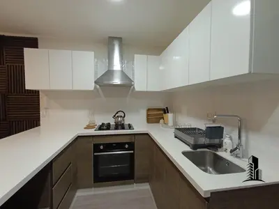 a kitchen with white cabinets and a sink and a stove at Perfect location in Barranco in Lima