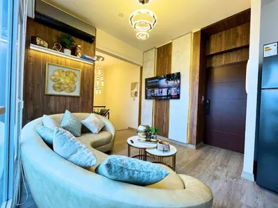 a living room with a couch and a television at Chelovirock- Luxury Penthouse Great Location in Lima