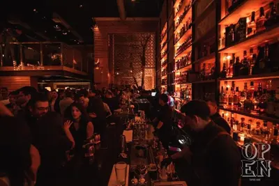a group of people standing at a bar in a room at Chelovirock- Luxury Penthouse Great Location in Lima