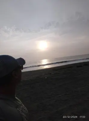 a man standing on the beach watching the sunset at Zen Home & Relax - Chincha in Chincha Baja