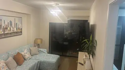a living room with a blue couch and a window at Luxury Aparment in San Isidro in Lima