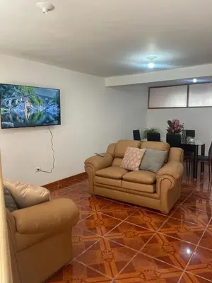 a living room with a couch and a table at Quechuas in Cusco
