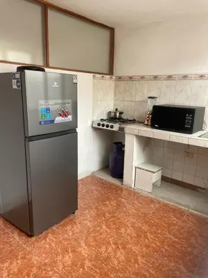 a kitchen with a stainless steel refrigerator in a room at Quechuas in Cusco
