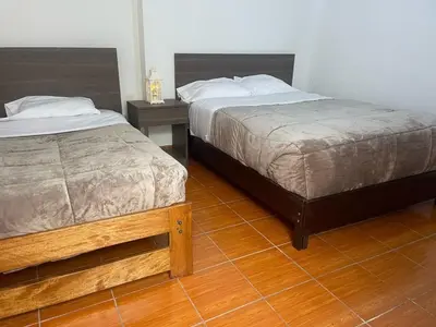 two beds sitting next to each other in a room at Quechuas in Cusco