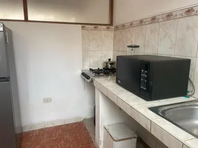 a kitchen with a microwave and a sink at Quechuas in Cusco