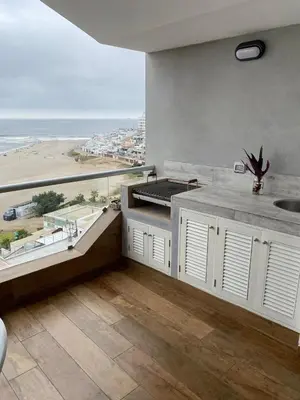 a large kitchen with a view of the beach at Apartment Rosi Beach & Pool Punta Hermosa in Punta Hermosa