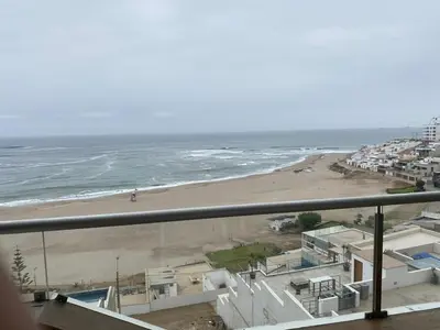 a view of a beach and the ocean from a balcony at Apartment Rosi Beach & Pool Punta Hermosa in Punta Hermosa
