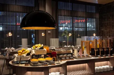 a buffet in a hotel with food on a table at Wyndham Grand Costa Del Sol Lima Airport in Lima