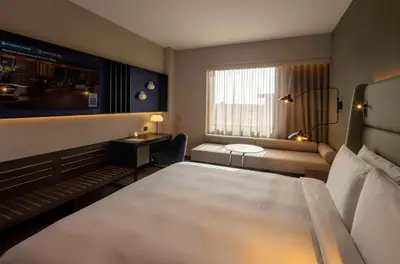 a hotel room with a bed and a window at Wyndham Grand Costa Del Sol Lima Airport in Lima