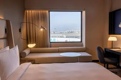 a hotel room with a bed and a window at Wyndham Grand Costa Del Sol Lima Airport in Lima