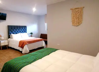 a hotel room with a bed and a couch at Hotel Sol de Ocucaje #4 in Ica