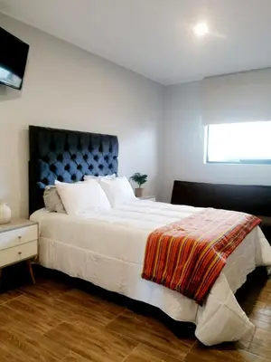 a bedroom with a large white bed and a window at Hotel Sol de Ocucaje #4 in Ica