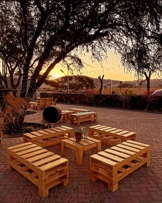 a group of wooden benches sitting in a park at Hotel Sol de Ocucaje #4 in Ica