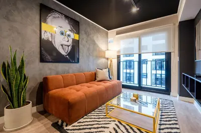 a living room with an orange couch and a glass table at Artline by Geko in Lima