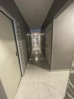 a long hallway in a building with a sign on the wall at Chelovirock- Luxury Penthouse Great Location in Lima