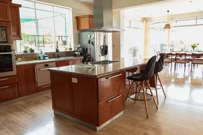 a kitchen with a island with a counter top at Casa campo en Cieneguilla 2,040m2 in Pachacamac