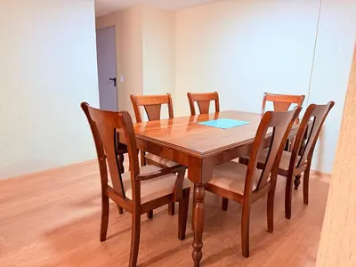 a wooden dining room table with six chairs at Acogedor Departamento en Lima in Lima