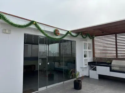 a house with a christmas garland on the side of it at Dormitorio con baño en departamento Miraflores in Lima