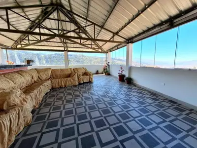 a large living room with couches in a room with windows at Jerusalen Inn-Dep 4 in Cusco