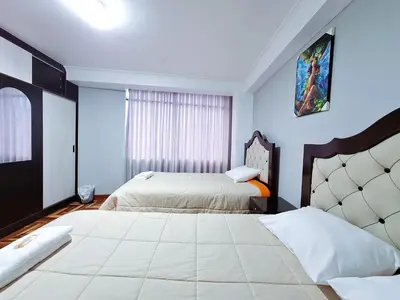 a hotel room with two beds and a window at Jerusalen Inn-Dep 4 in Cusco