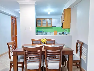 a dining room with a wooden table and chairs at Jerusalen Inn-Dep 4 in Cusco