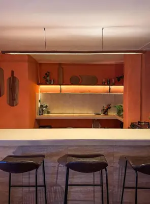 a kitchen with a bar with three stools at House Sacha 1BR Great View Huanuco in Huánuco