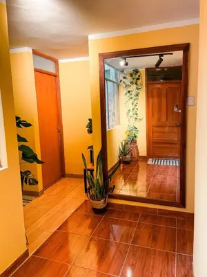 a living room with a door and a wooden floor at House Sacha 1BR Great View Huanuco in Huánuco