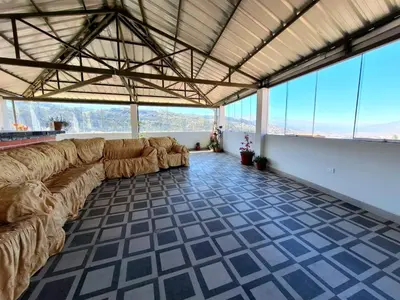 a large living room with couches in a room with windows at Jerusalen Inn -Dep 1 in Cusco