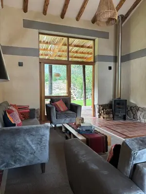 a living room with two couches and a fireplace at Luxury house in Urubamba, Cusco, Perú in Urubamba