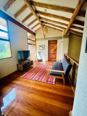 a living room with a couch and a television at Luxury house in Urubamba, Cusco, Perú in Urubamba