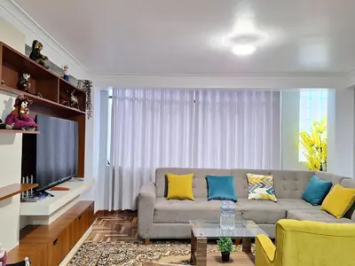 a living room with a couch and a tv at Jerusalen Inn-Dep 2 in Cusco