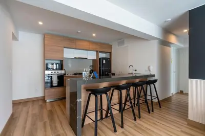 a kitchen with a counter and bar stools at Eco 28 by Geko in Lima