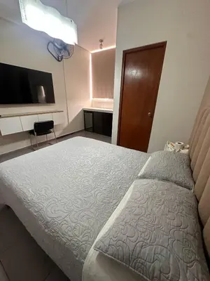 a hotel room with a bed and a television at Hotel Gboss in Punta Hermosa