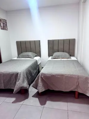 two beds sitting next to each other in a room at Hotel Gboss in Punta Hermosa