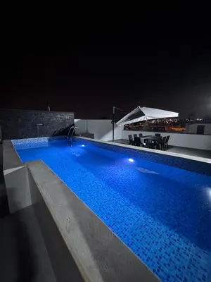 a swimming pool on top of a building at night at Casa de Playa en Pulpos Punta Hermosa in Lurín