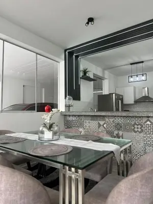 a dining room with a table and a mirror at Casa de Playa en Pulpos Punta Hermosa in Lurín
