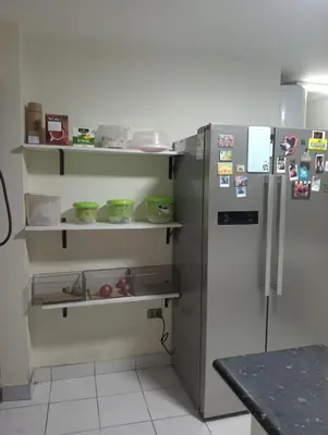 a kitchen with a stainless steel refrigerator at Spacious Apartment - Los Olivos in Lima