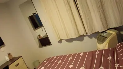 a bedroom with a bed and a dresser and a window at Spacious Apartment - Los Olivos in Lima