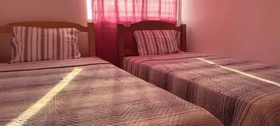 two beds sitting next to each other in a bedroom at Departamento 5p Lima Centro 3 dormitorios 4 camas in Lima