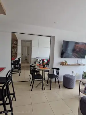 a dining room and kitchen with a table and chairs at Departamento a un paso de playa Pulpos y Arica in Lurín